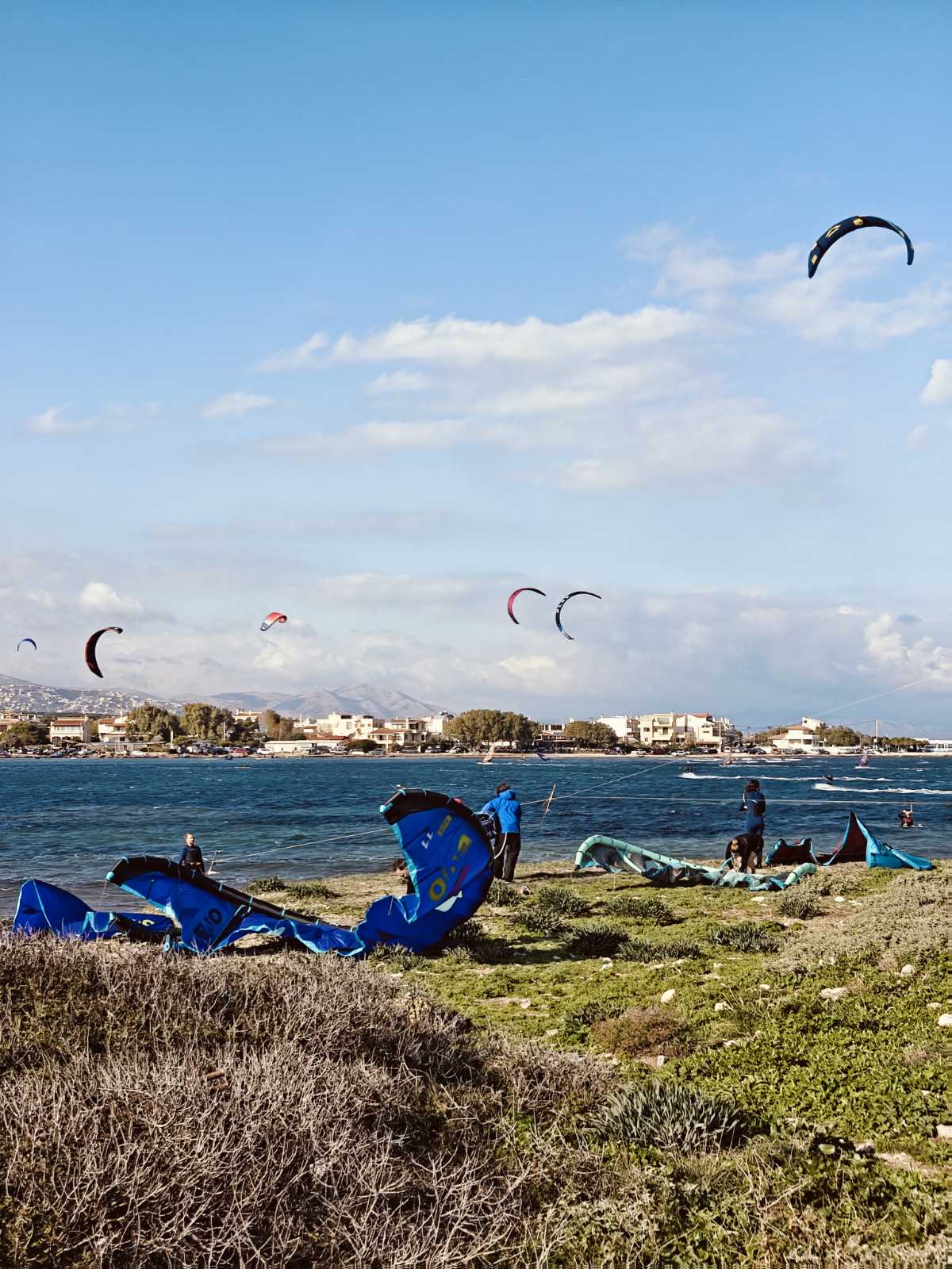 Kitesurfers preparing their equipment at Nissakia beach in Loutsa, near Athens