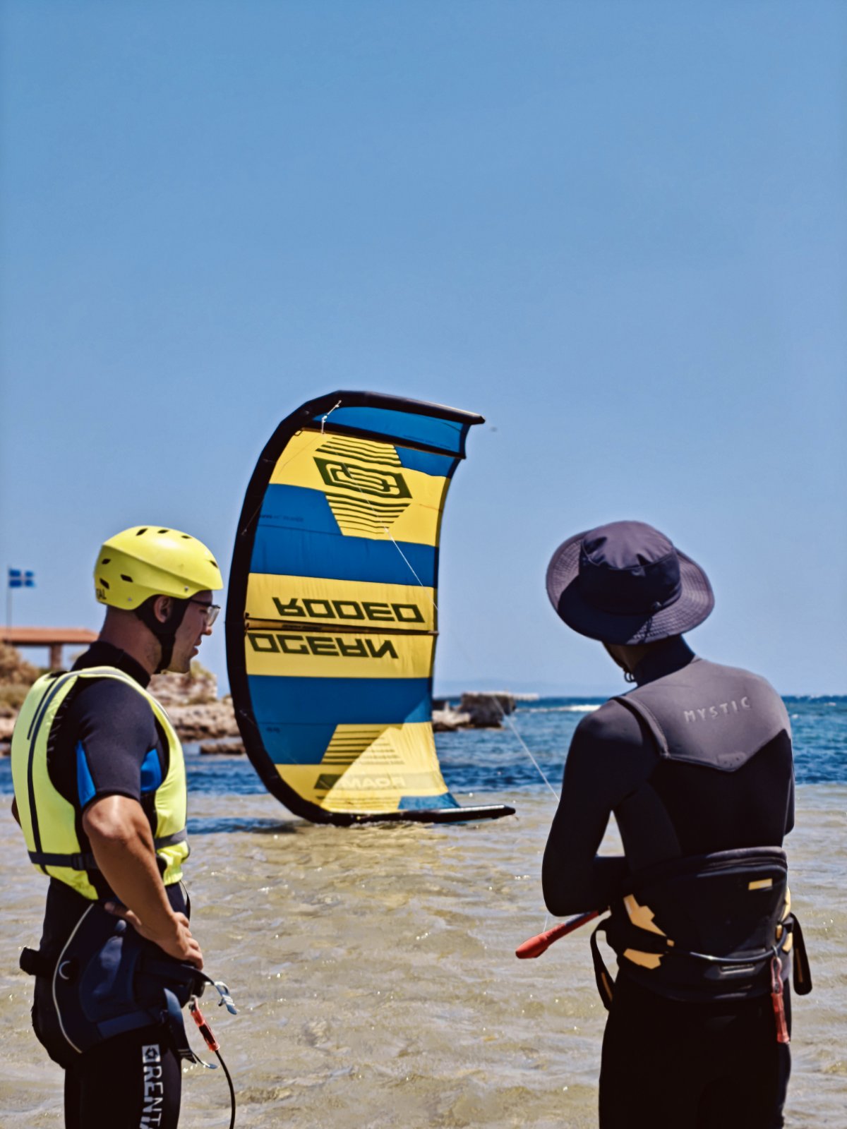 Kitesurfers preparing a kite in shallow water at Nissakia, Loutsa
